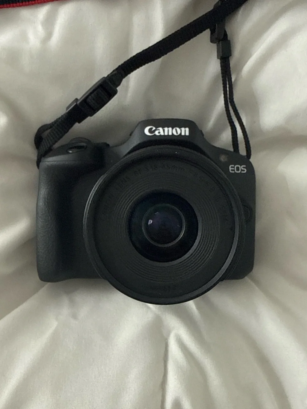 Canon EOS R100 Compact Mirrorless Camera with Red-Trim Strap – Black